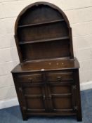 A 20TH CENTURY OAK DRESSER, the arched top with two shelves, atop a base with two drawers over