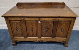 AN EARLY 20TH CENTURY OAK BLANKET CHEST, with a raised back and a hinged lid, most panels have