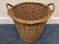 A CYLINDRICAL TAPERED WICKER BASKET, with twin handles Dimensions:diameter 52cm x height 50cm
