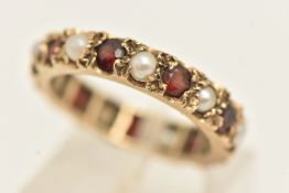 A YELLOW METAL GEM SET FULL ETERNITY RING, set with garnets and seed pearls, stamped 9ct, ring
