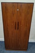G PLAN FRESCO, A MID-CENTURY TEAK DOUBLE DOOR WARDROBE, with a fitted interior, raised on castors