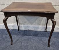 AN EARLY 20TH CENTURY MAHOGANY TABLE, with concave edges, raised on cabriole legs, along with a