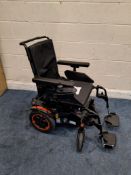 A SUNRISE MEDICAL QUICKIE ELECTRIC WHEEL CHAIR with charger and seat cushion (PAT pass and