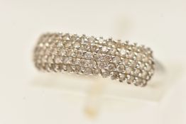A WHITE METAL GEM SET RING, a white metal band ring pave set with circular cut cubic zirconia,