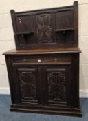 AN EARLY 20TH CENTURY OAK SIDEBOARD, the raised back with two shelves and carved details, atop a