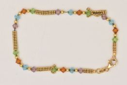 A 9CT YELLOW GOLD BEADED BRACELET, set with yellow gold beads and coloured paste beads, fitted