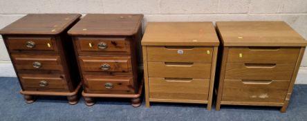 A PAIR OF LIGHT OAK THREE DRAWER BEDSIDE CHESTS, along with a pair of pine three drawer bedside