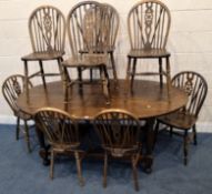 AN EARLY 20TH CENTURY OAK OVAL DINING TABLE, raised on block and turned legs, along with a set of