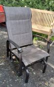 A 'PAGODA' ROCKING GARDEN CHAIR with an aluminium frame and fabric seat and back and an aluminium