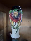 A MOORCROFT POTTERY ANNA LILY VASE, the baluster vase tube lined with red and orange lilies on a