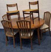 A MID-CENTURY TEAK EXTENDING DINING TABLE, with a single fold out leaf, raised on cylindrical
