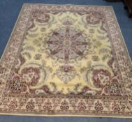 A YELLOW GROUND RECTANGULAR WOOLLEN RUG, with repeating foliate patterns, surrounded by a multi-
