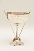A GEORGE V SILVER TROPHY CUP, a small cup with golf club handles and golf ball on the round base,