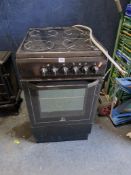 AN INDESIT ELECTRIC COOKER with a four ring glass hob and single oven width 50cm, depth 65cm, height