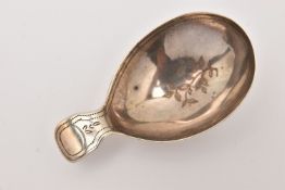 A GEORGIAN SILVER CADDY SPOON, with bright cut pattern, small handle, hallmark rubbed London 1812,