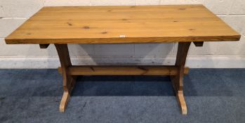 A MODERN PINE RECTANGULAR TABLE, raised on trestle-style legs, united by a stretcher Dimensions: