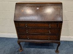 AN EARLY 20TH CENTURY MAHOGANY BUREAU, the fall front door enclosing a fitted interior, over three