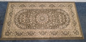 A SMALL GREEN GROUND RECTANGULAR WOOLLEN RUG Dimensions:141cm x 82 Condition Report:in need of a