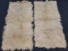 TWO CREAM ANIMAL HIDE RUGS Dimensions:160cm x 74cm Qty: 2 Condition Report:general signs of usage