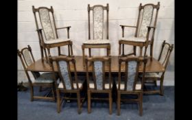 LUCIAN ERCOLANI, AN ERCOL ELM AND BEECH EXTENDING DINING TABLE, with three additional leaves, raised