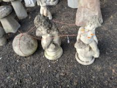 THREE CONCRETE GARDEN ORNAMENTS, including an orb 33cm in diameter, a small child sat atop an
