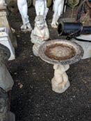 TWO CONCRETE GARDEN FIGURES, including a bird bath with a small child holding the bowl aloft, and