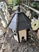 A MODERN WOODEN DOVE COTE, with a hexagonal pitched roof and six perches, 92cm high Condition