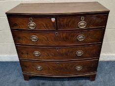 A GEORGIAN MAHOGANY BOW FRONT CHEST OF TWO SHORT OVER THREE LONG GRADUATED DRAWERS, raised on