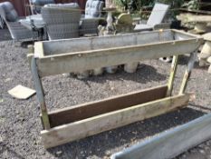 A GALVANISED STEEL HORSE TROUGH ON A WOODEN FAMED STAND, the trough is 170cm long with drain holes