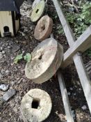 EIGHT VINTAGE QUERN STONES AND TWO WALL MASKS, the stones are of various thicknesses and diameters