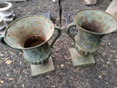 A PAIR OF CAST IRON CAMPAGNA URNS, with handles and fluted detail to bowls, 60 cm high Condition