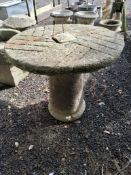 A MODERN ROUND CONCRETE GARDEN TABLE, with a pedestal base and plank effect top Dimensions:77cm