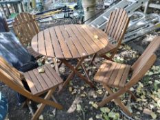 A HARDWOOD FOLDING GARDEN TABLE AND FOUR MATCHING CHAIRS table diameter 92cm Qty: 5 Condition