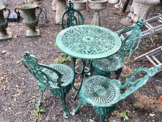 A CAST ALUMINIUM GARDEN TABLE with four chairs, with a 70cm diameter pierced fretwork top Qty: 5