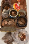 A cardboard box containing a large quantity of pennies and halfpennies in tins and bags, around 2000