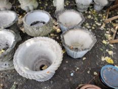 FOUR CONCRETE GARDEN PLANTERS including a two-piece urn with acanthus leaf detail 47cm high, a