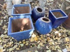 FIVE BLUE GLAZED GARDEN PLANTERS AND ORNAMENTS, including a pair of 40cm diameter orbs, and three