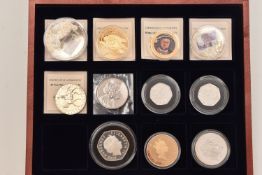 A wooden case containing 11 commemorative coins, to include 3 Alderney Proof £5 dated 2006, 2007,