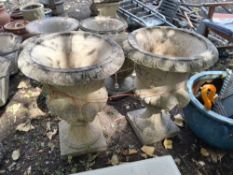A PAIR OF CONCRETE GARDEN URNS constructed in two pieces with mask handles, both 65cm high Qty: 2