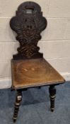 AN EARLY 20TH CENTURY CHAIR, the backrest with Eagle and Templar cross, a dished seat, raised on