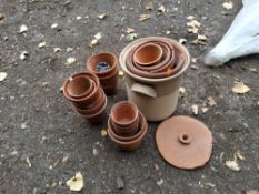 A COLLECTION OF TERRACOTTA PLANT POTS of various sizes and an earthenware bread bin Condition