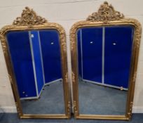 A LARGE PAIR OF ORNATE GILT WOOD BEVELLED EDGE WALL MIRRORS, with scantilly clad putto, scrolled and