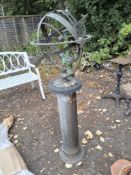 A COPPER ARMILLARY SPHERE SUNDIAL with arrow pointer, raised markings to internal ring with a