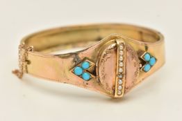 A VICTORIAN YELLOW METAL HINGED BANGLE, displaying on oval locket with split pearl detail, opens