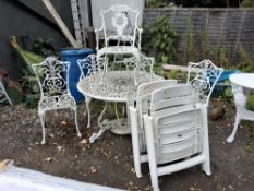 A CAST ALUMINIUM GARDEN TABLE, 110cm diameter pierced fretwork and five off similar chairs,