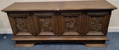 A 20TH CENTURY OAK SIDEBOARD, fitted with four cupboard doors carved with various craftsmen