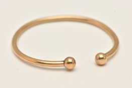 A 9CT GOLD TORQUE BANGLE, polished hollow design with ball terminals, hallmarked 9ct Birmingham,