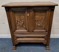 A 20TH CENTURY OAK MEDIA CABINET, the double cupboard doors depicting craftsmen scenes, on runners