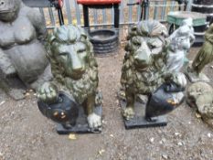 AN OPPOSING PAIR OF CONCRETE LION FIGURES, seated, holding a shield. VERY HEAVY PURCHASER WILL