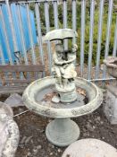 A HENRI STUDIO CONCRETE WATER FEATURE, the figures to top with an umbrella thats the spout, bowl